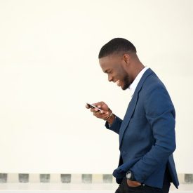 Man walking while looking at his phone