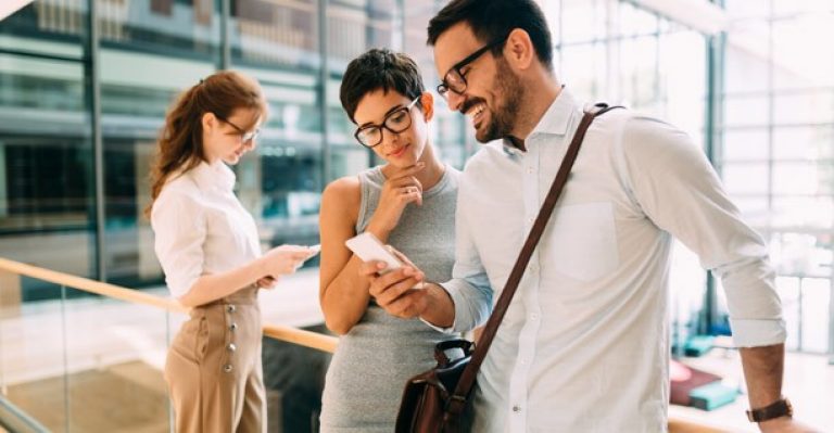 man and woman looking at a cellphone