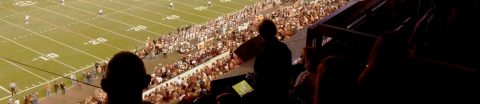 View of football field, fans in the stand